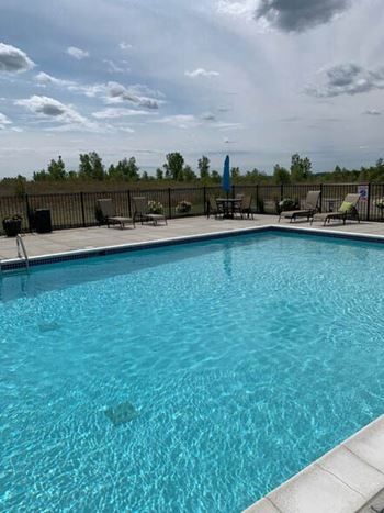 A swimming pool with a black fence and a sitting